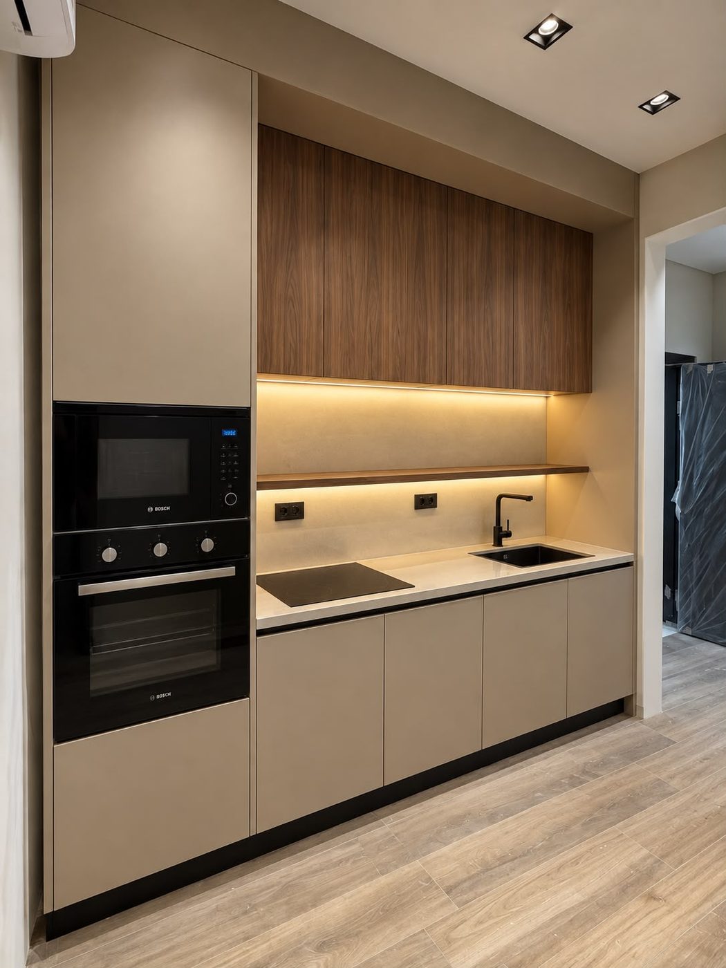 Kitchen with a tall built-in oven column, walnut upper cabinets and a lit stone backsplash